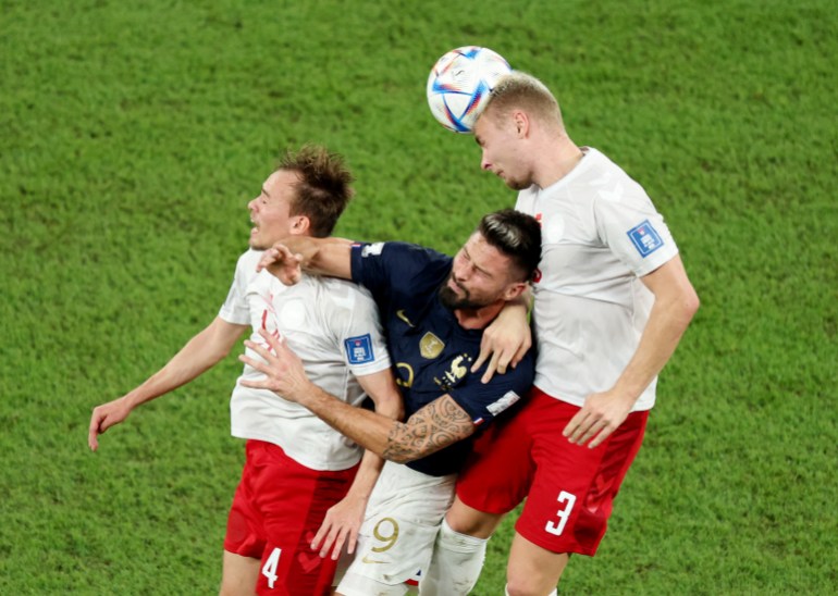 Denmark's Mikkel Damsgaard and Victor Nelsson in action with France's Olivier Giroud