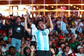 Argentina fan celebrates in Al Bidda Park after Argentina's Lionel Messi scores their first goal.