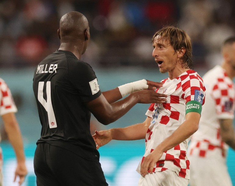 Croatia's Luka Modric clashes with Canada's Kamal Miller 