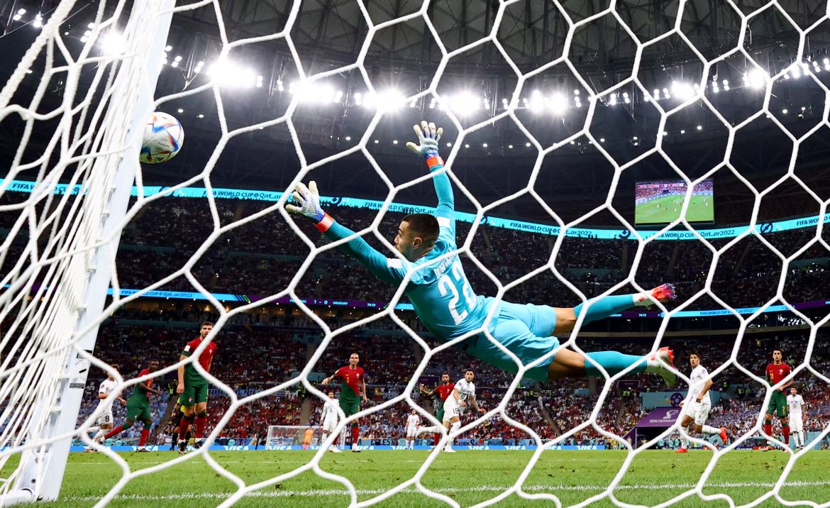 Portugal's Diogo Costa attempts a save but the ball ends up hitting the post.
