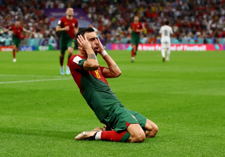 Bruno Fernandes celebrates a goal on his knees while grabbing his head.