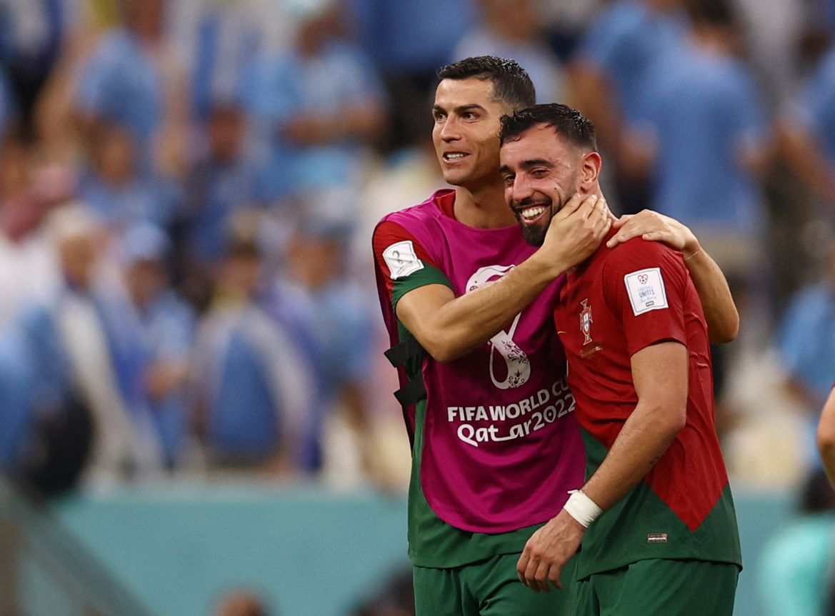 Portugal's Cristiano Ronaldo and Bruno Fernandes celebrate after the match.