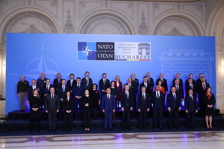 NATO Secretary General Jens Stoltenberg poses with foreign ministers of NATO countries during the family photo at their meeting in Bucharest, Romania November 29, 2022. REUTERS/Stoyan Nenov