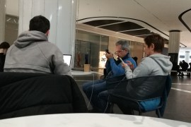 A Ukrainian family recharges their gadgets at a shopping mall in the capital, Kyiv [Mansur Mirovalev/Al Jazeera]