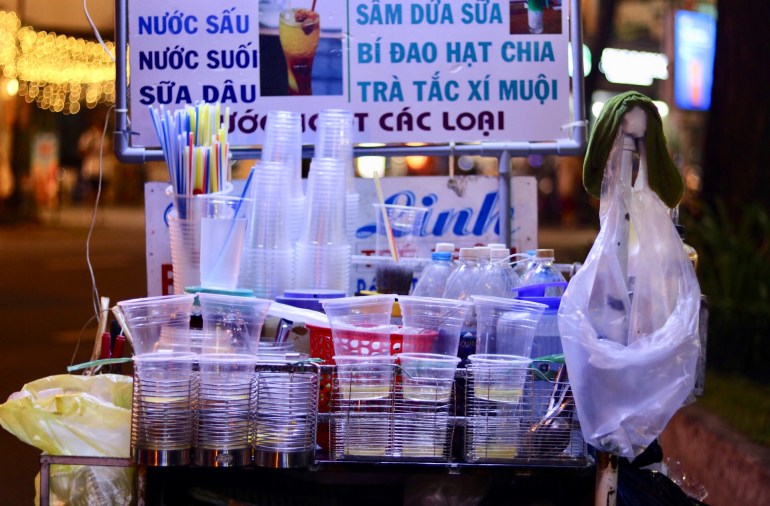 Single use plastic bottles, cups and straws at a roadside drinks stall in Ho Chi Minh City