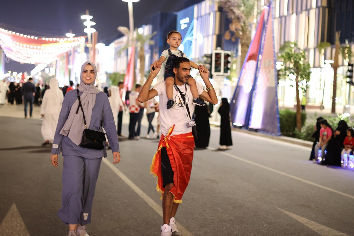 A family walk along the road during pre FIFA World Cup festivities