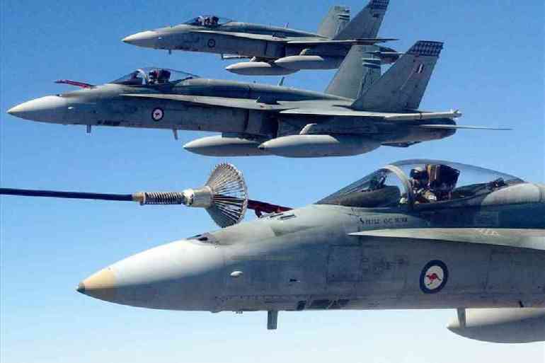 Royal Australian Air Force F/A-18 Hornet fighter jets perform air-to-air refuelling while participating in "Exercise Pitch Black", near Darwin, Australia, in 2004 [File: AP]