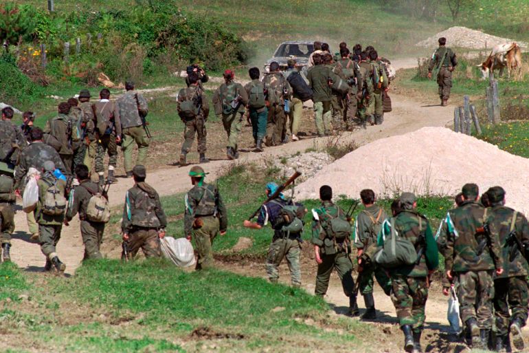 FILE - In this Sept. 28, 1995. file photo, a line of Bosnian government troops makes its way to the front-line near Mrkonjic Grad 120kms (80mls) north west of Sarajevo, Bosnia. While it brought an end to the fighting, the Dayton peace agreement baked in the ethnic divisions, establishing a complicated and fragmented state structure with two semi-autonomous entities, Serb-run Republika Srpska and a Federation shared by Bosniak and Croats, linked by weak joint institutions. (AP Photo/Darko Bandic, File)
