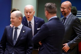 US President Joe Biden touches the shoulder of German Chancellor Olaf Scholz, as they arrive for a round table meeting at an EU summit in Brussels on March 24, 2022 [File: AP/Olivier Matthys]