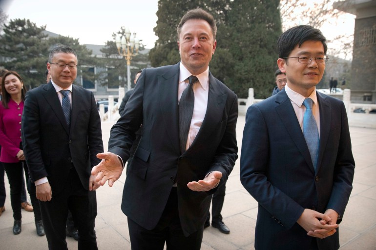 FILE - Tesla CEO Elon Musk, center, gestures as he waits for a meeting with Chinese Premier Li Keqiang at the Zhongnanhai leadership compound in Beijing, Wednesday, Jan. 9, 2019. Many people are puzzled on what a Elon Musk takeover of Twitter would mean for the company and even whether he’ll go through with the deal.  If the 50-year-old Musk’s gambit has made anything clear it’s that he thrives on contradiction. (AP Photo/Mark Schiefelbein, Pool, File)