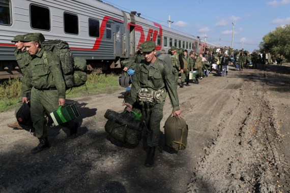 Russian recruits walk to take a train at a railway station in Prudboi, Volgograd, Russia.
