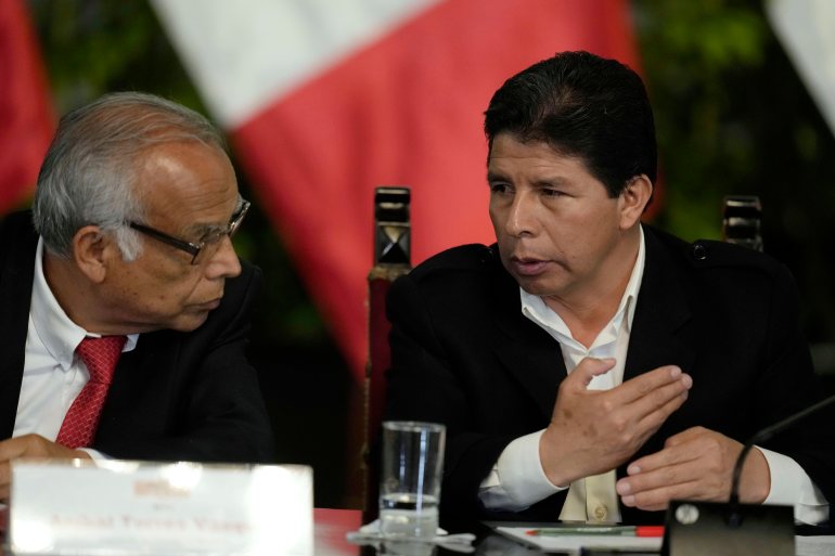 Peru´s President Pedro Castillo talks with his Prime Minister Anibal Torres as they attend a press conference