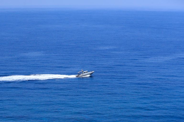 A Lebanese navy boat patrols in the Mediterranean Sea in front of a UN post.