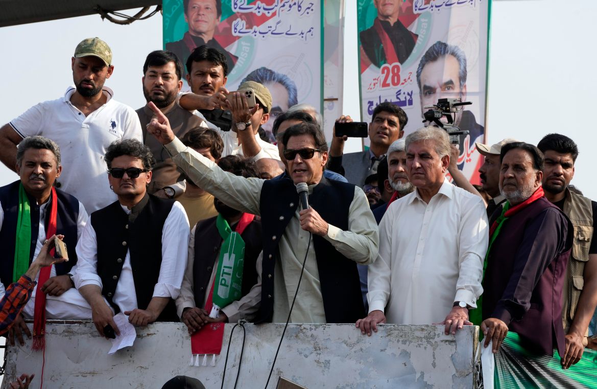 Pakistan's former Prime Minister Imran Khan, center, addresses to his supporters at a rally in Lahore, Pakistan