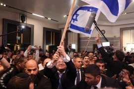 Israeli far-right lawmaker Itamar Ben-Gvir waves the Israeli flag after first exit poll results for the parliamentary election, at his party's headquarters in Jerusalem, November 2, 2022