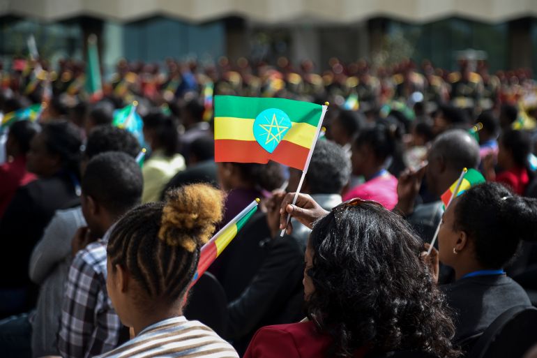 women holds Ethiopian flag at ceremony to remember fallen soldiers