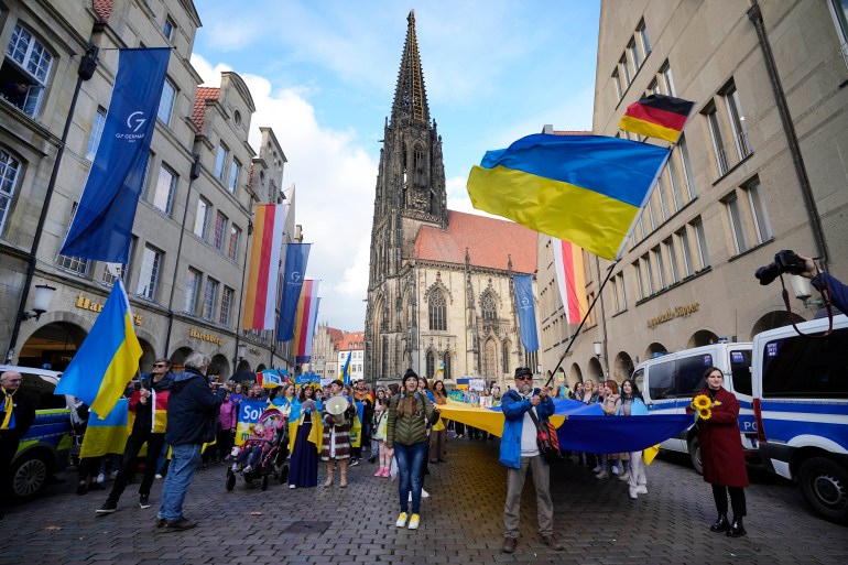People protest against Russia's war in Ukraine outside the G7 Foreign Ministers' Meeting in Muenster, Germany, Friday, Nov. 4, 2022. (AP Photo/Martin Meissner)