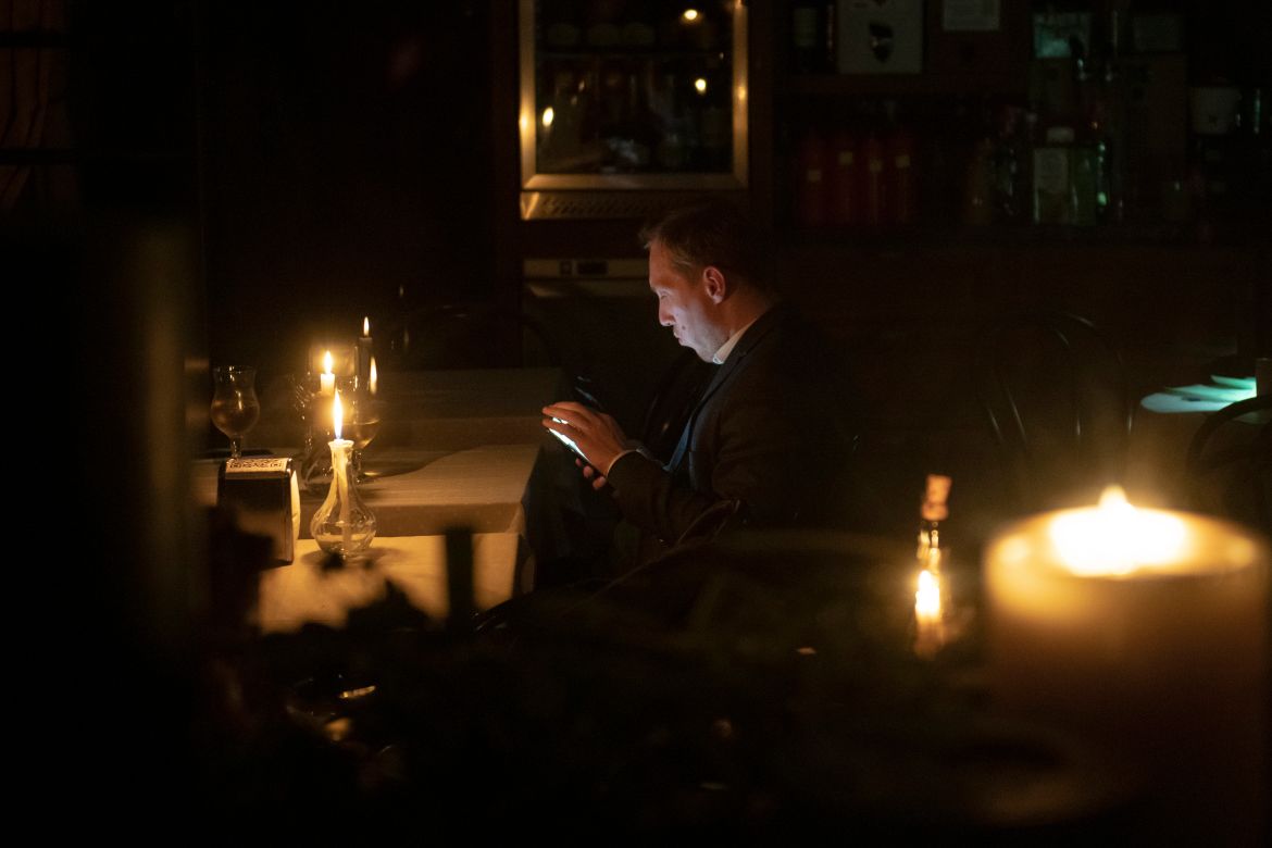 A man sits in a cafe during a blackout in Kyiv.
