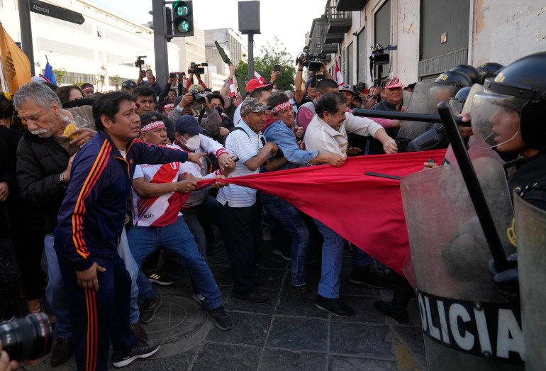 Anti-government protesters clash with riot police near the government palace, in Lima, Peru, Saturday, Nov. 5, 2022. (AP Photo/Martin Mejia)