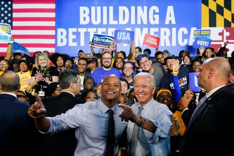 US President Joe Biden smiling and pointing alongside Maryland Democratic gubernatorial candidate Wes Moore in front of a banner reading Building a Better America.