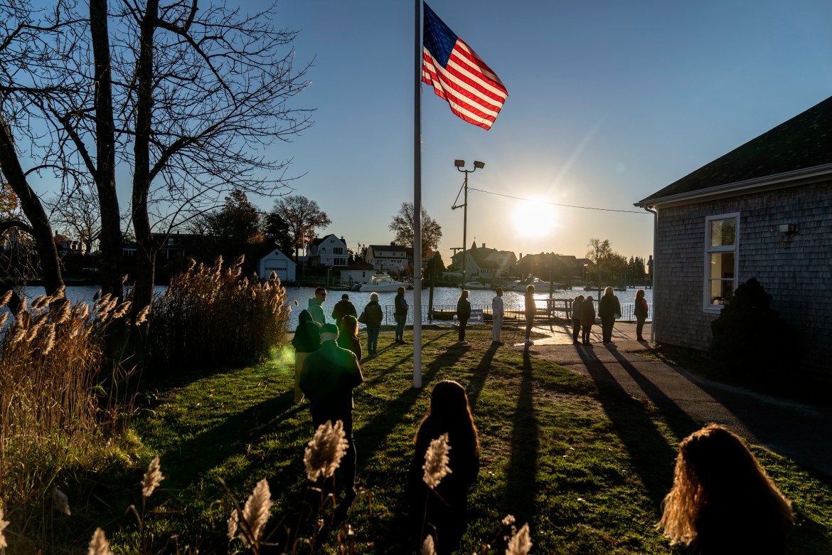 Voters line up to cast their ballots in the midterm election at the Aspray Boat House in Warwick, R.I