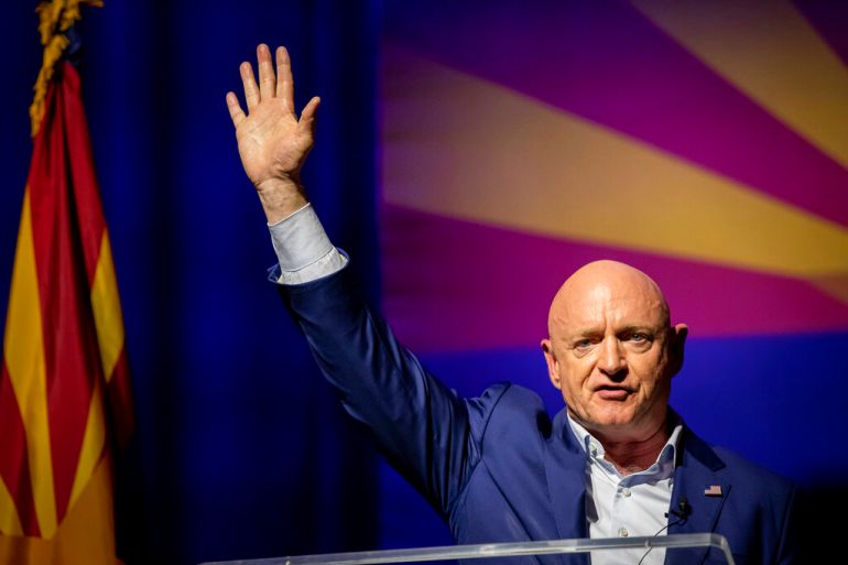 Sen. Mark Kelly, D-Ariz., waves supporters goodnight during an election night event in Tucson, Ariz., Tuesday, Nov. 8, 2022. (AP Photo/Alberto Mariani)