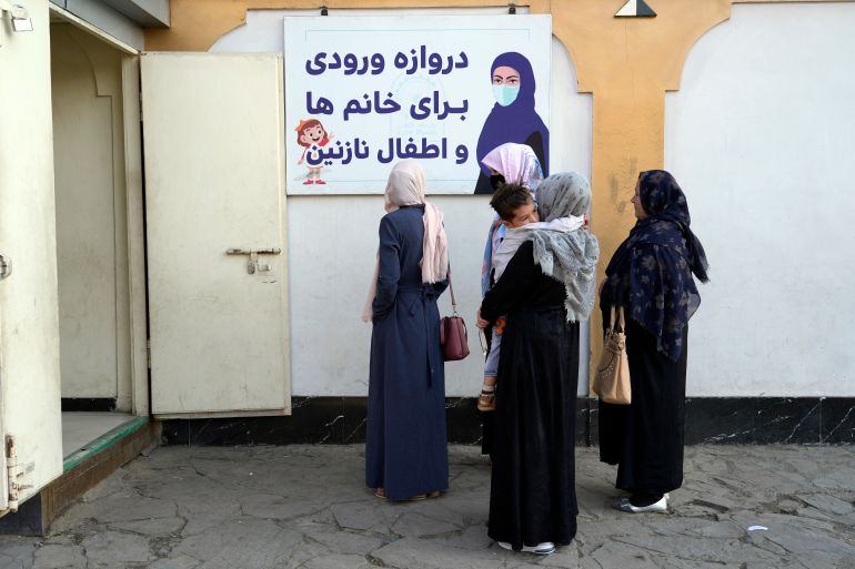 Afghan women stand outside an amusement park, in Kabul, Afghanistan