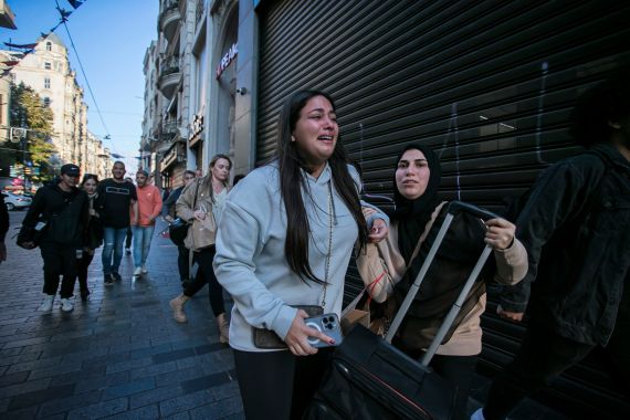 People leave the area after an explosion on Istanbul's popular pedestrian Istiklal Avenue.