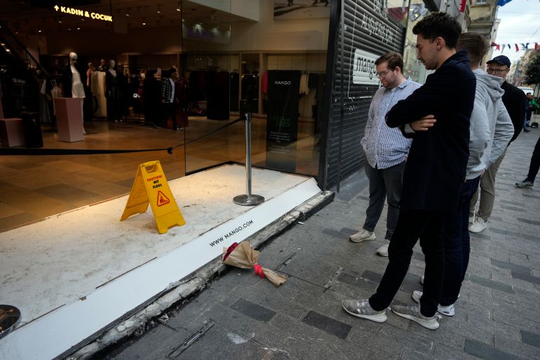 People view the spot of Sunday's explosion on Istanbul's popular Istiklal Avenue