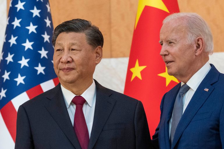 US President Joe Biden stands with Chinese President Xi Jinping