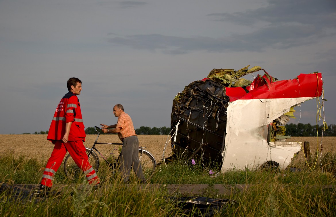 A paramedic walks by a part of fuselage at the crash site.