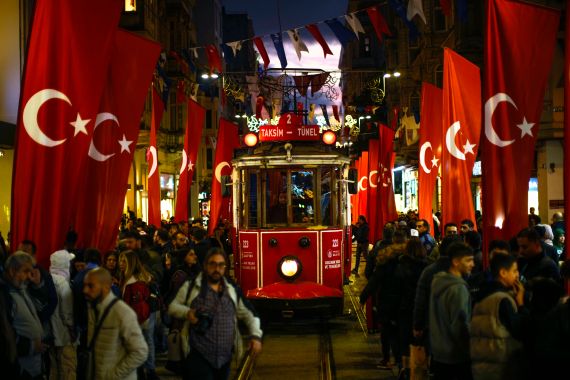 A tram rides past the spot of Sunday's explosion on Istanbul's popular pedestrian Istiklal Avenue.