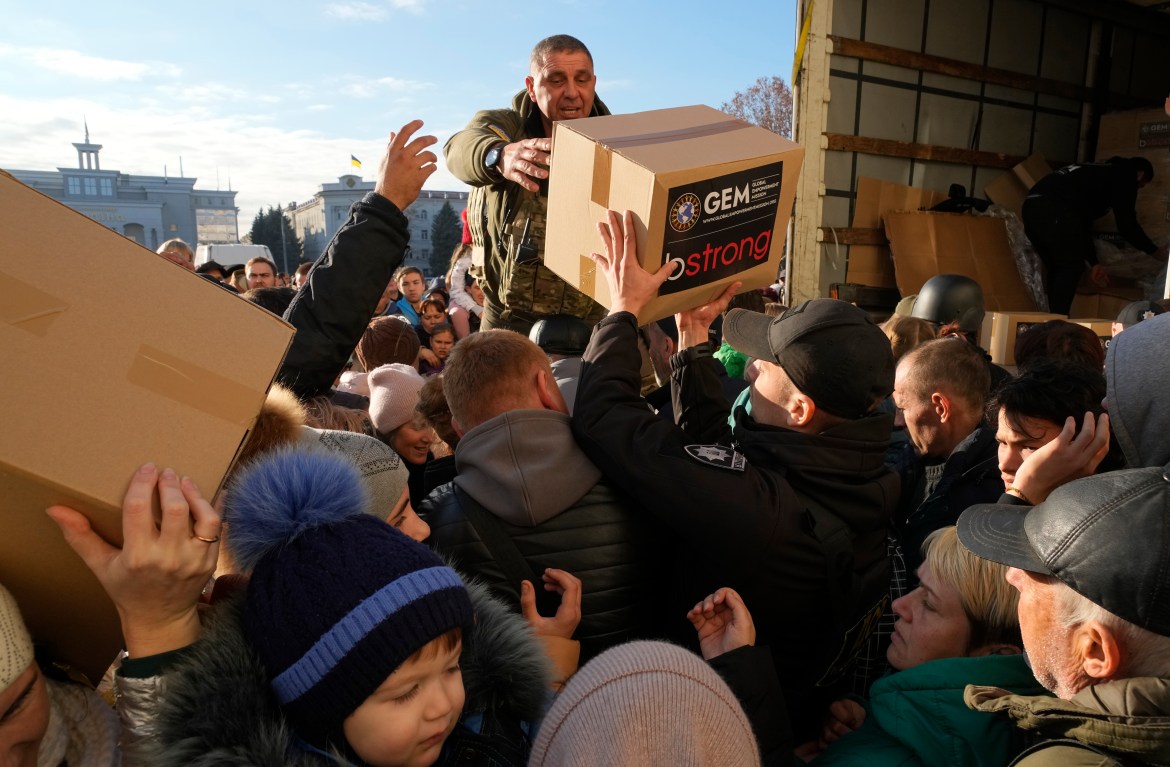People receive humanitarian aid on central square in Kherson