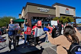 Starbucks workers take part in a demonstration in November 2022 [File: Matt York/AP Photo] (AP Photo)