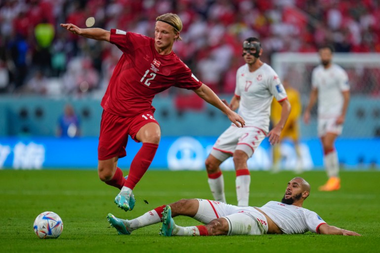 Denmark's Kasper Dolberg, left, vies for the ball with Tunisia's Aissa Laidouni during their match.