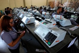 Brazil Electoral Court employees work on the final stage of sealing electronic voting machines
