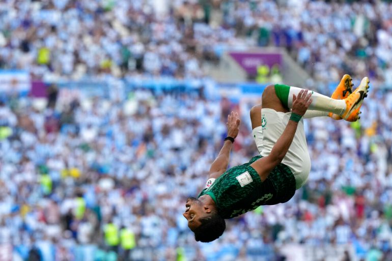 Saudi Arabia's Salem al-Dawsari celebrates with a flip after scoring his side's second goal during the World Cup group C football match between Argentina and Saudi Arabia.