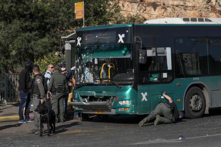 Israeli police inspect the scene of an explosion at a bus stop in Jerusalem