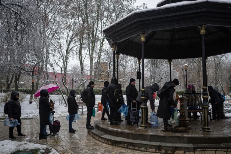 People wait in line to collect water, in Kyiv, Ukraine, November 24, 2022