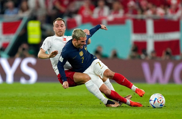 Denmark's Christian Eriksen, left, and France's Antoine Griezmann challenge during the World Cup group D soccer match between France and Denmark, at the Stadium 974 in Doha, Qatar, Saturday, Nov. 26, 2022. (AP Photo/Martin Meisner)