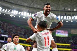 Morocco's Yahya Jabrane jumps into Abdelhamid Sabiri's arms to celebrate after Sabiri scored a goal during the World Cup group F soccer match between Belgium and Morocco, at the Al Thumama Stadium in Doha, Qatar.