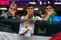 Spectators hold photo of former German international Mesut Ozil on the stands at the end of the World Cup group E football match between Spain and Germany, at the Al Bayt Stadium in Al Khor , Qatar.