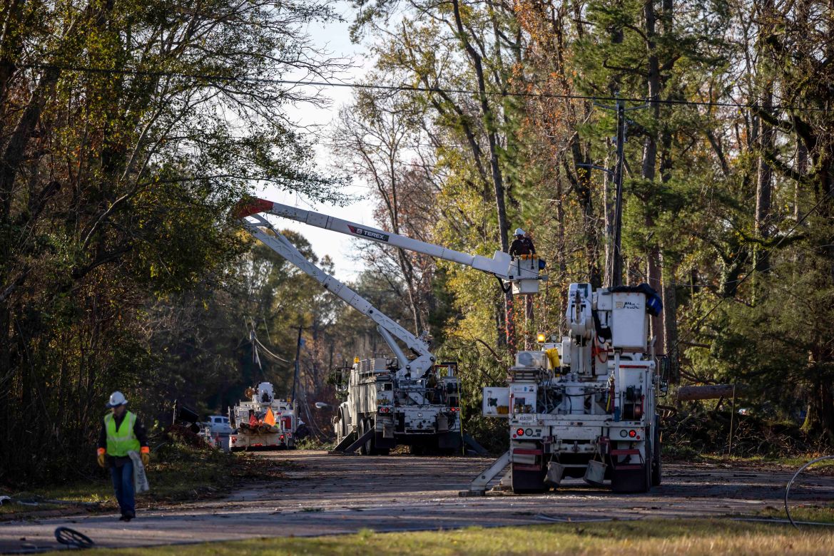 Utility workers repair power lines in the aftermath from Tuesday's severe weather