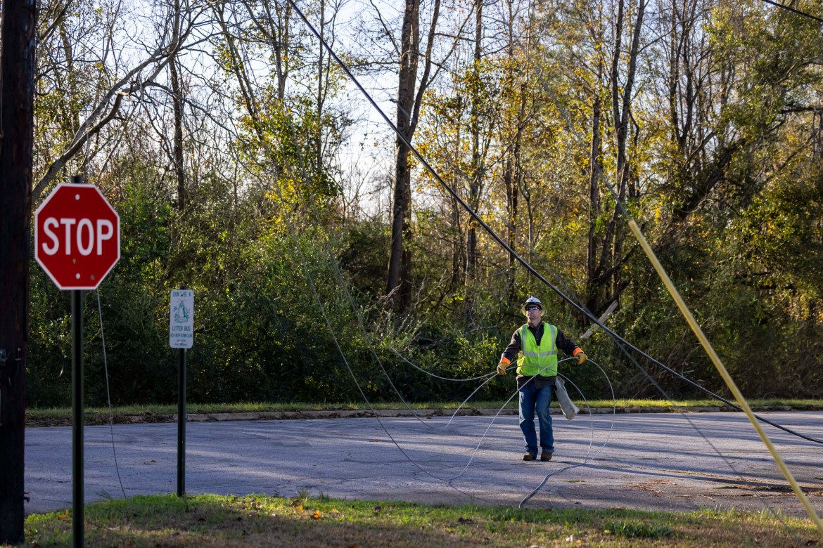 Utility workers repair power lines in the aftermath from Tuesday's severe weather,