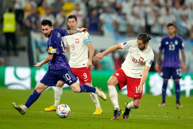rgentina's Lionel Messi, left, and Poland's Grzegorz Krychowiak, right, battle for the ball during the World Cup group C soccer match between Poland and Argentina at the Stadium 974 in Doha, Qatar, Wednesday, Nov. 30, 2022. (AP Photo/Natacha Pisarenko)