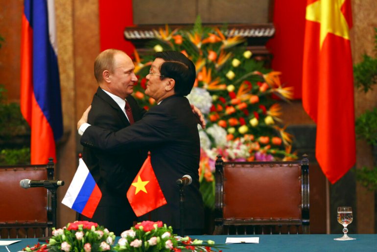 Russian President Vladimir Putin and then-Vietnamese President Truong Tan Sang embrace at the Presidential Palace in Hanoi, Vietnam in 2013 [File: Na Son Nguyen/pool/AP]