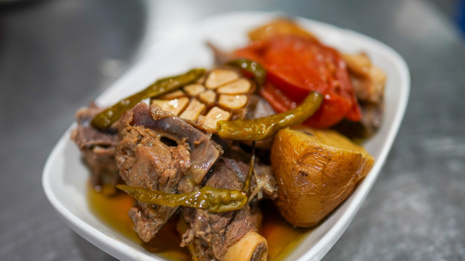 A dish of stewed mutton, potato, tomato, garlic and chillies