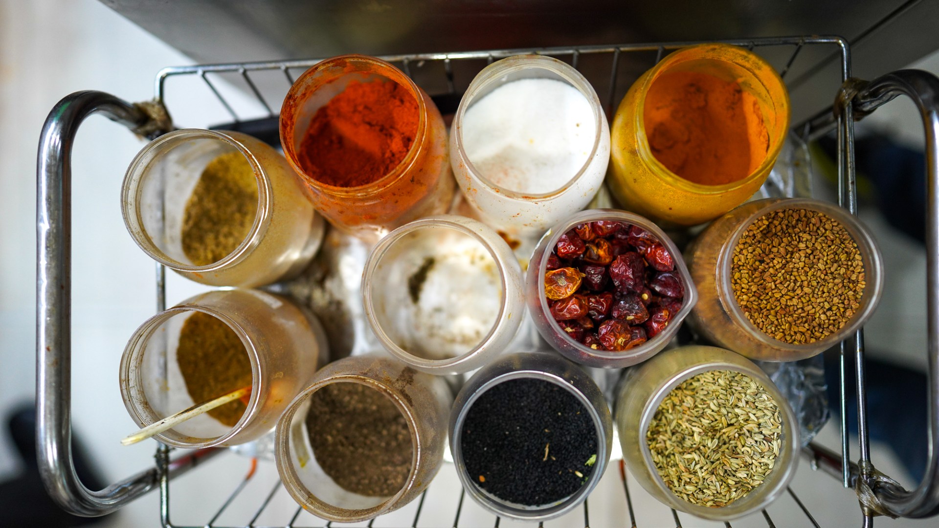 A view of the well-used spice rick in the kitchen of Punjab restaurant