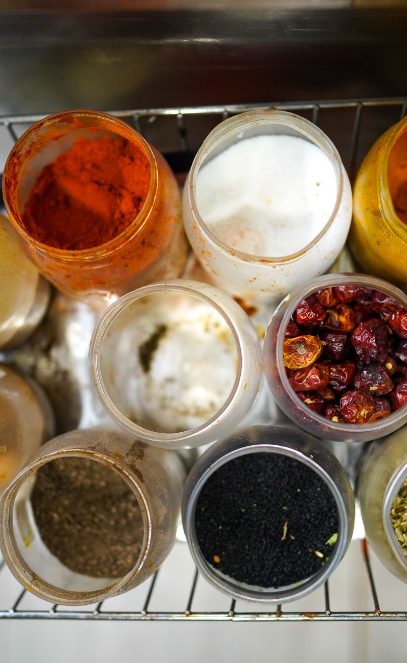 A view of the well-used spice rick in the kitchen of Punjab restaurant