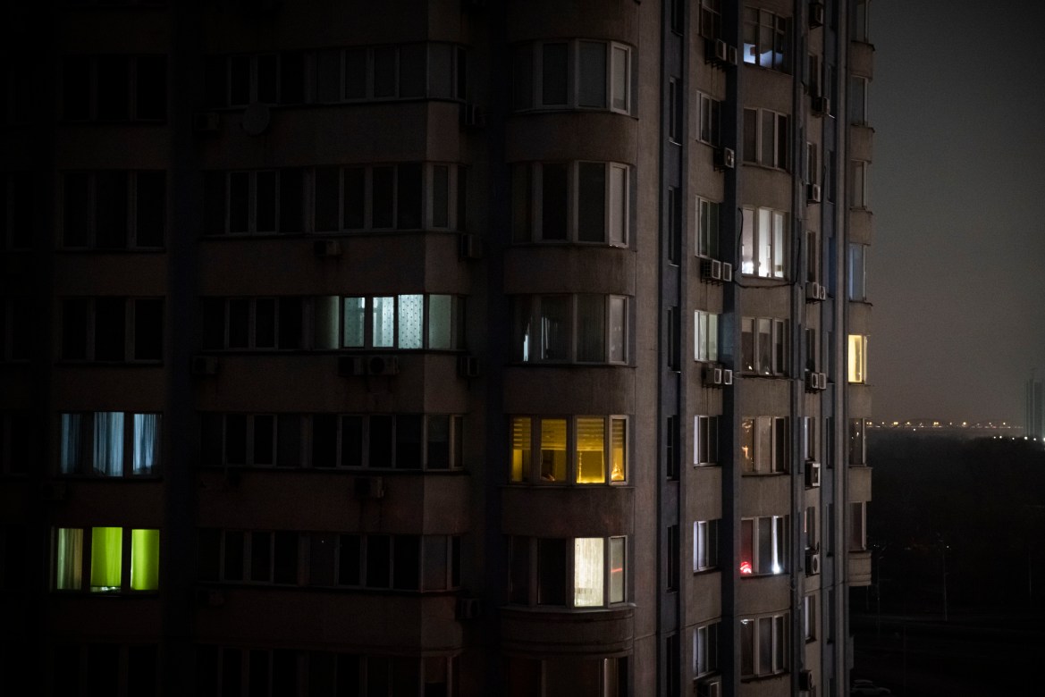 Apartment blocks stand in near total darkness